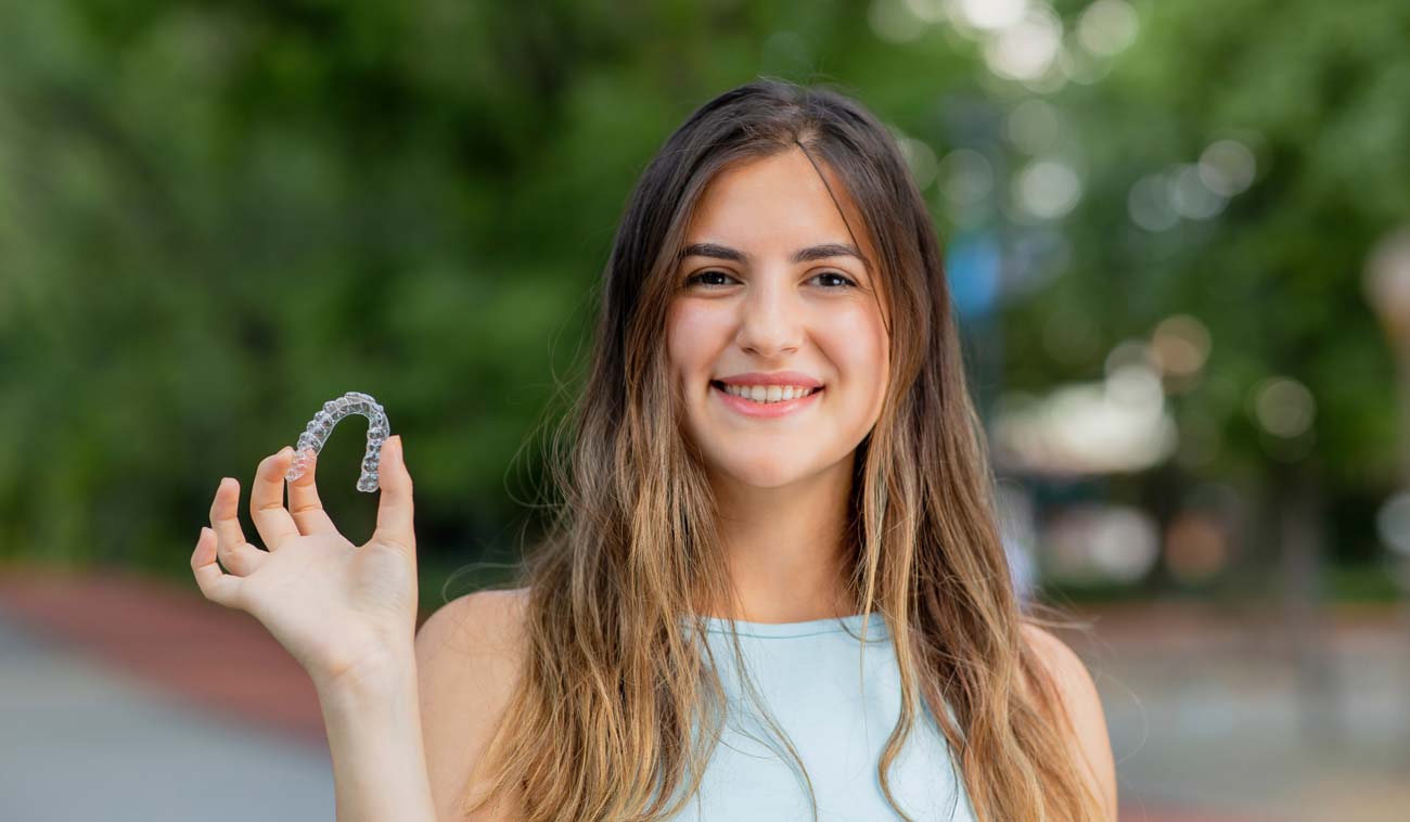 Girl Holding Invisalign Tray